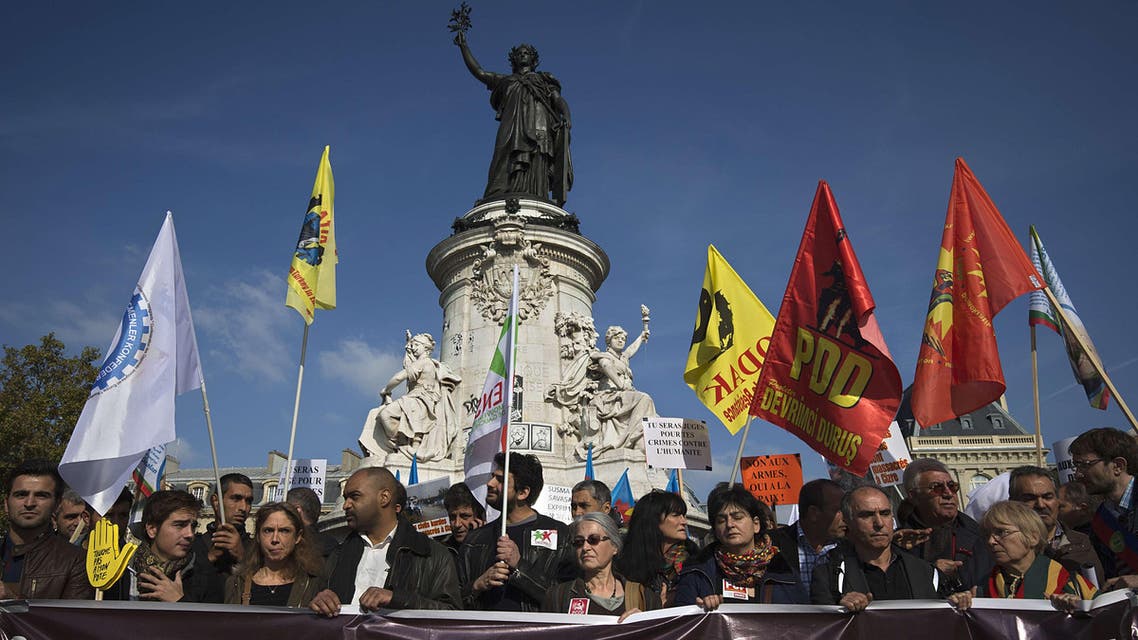 9609 - Paris, Paris, FRANCE : People take part in a demonstration organised by the Kurdish Democratic Council of France on Place de la Republique in Paris, on October 11, 2015, in support of the victims of the suicide bomb attack which occured in Ankara on October 10. Turkey woke in mourning after at least 95 people were killed by suspected suicide bombers at a peace rally of leftist and pro-Kurdish activists in Ankara, the deadliest such attack in the country's recent history. Thousands also took to the streets in solidarity in Paris, Strasbourg and Marseille in France, as well as in Zurich in Switzerland. The banner reads "Custody, Bloody Attacks, Isolation". AFP PHOTO / JOEL SAGET