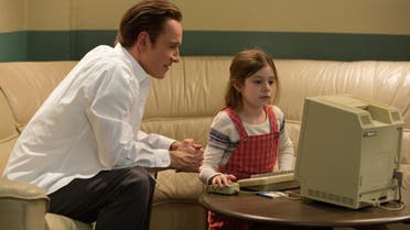 In this image released by Universal Pictures, Michael Fassbender, left, as Steve Jobs and Makenzie Moss as a young Lisa Jobs, appear in a scene from the film, Steve Jobs. (AP) 