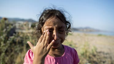 Yasmine, a 6-year-old migrant from Deir Al Zour in war-torn Syria, cries at the beach after arriving on the Greek island of Lesbos September 11, 2015. (Reuters)