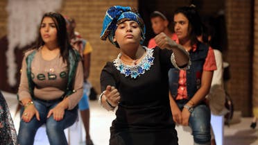 Iraqi girls from the Dar al-Zuhur orphanage perform in a play at the Theatre Forum in the capital Baghdad on October 1, 2015.