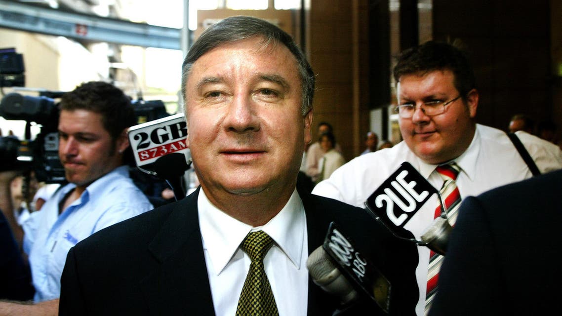 A file photo taken on February 28, 2006, shows former Chairman of the Australian Wheat Board Trevor Flugge (C) leaving the Cole Inquiry in Sydney.