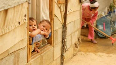  Syrian refugee children look on from a window during a sandstorm at a refugee camp on September 8, 2015 near the Bekaa Valley village of Taalabaya Lebanon
