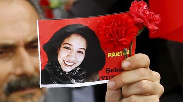 A member of the left-wing Labour Party holds a picture of Sebnem Yurtman, a victim of Saturday's bomb blasts, during a commemoration in Ankara. (Reuters)