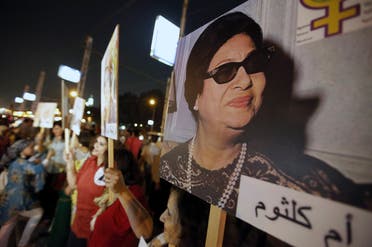 Women carry a picture of late Egyptian singer Umm Kalthoum during a protest supporting women's rights. (Reuters)