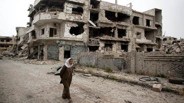 n this June 5, 2014, file photo, a woman walks through a devastated part of Homs, Syria. (AP)