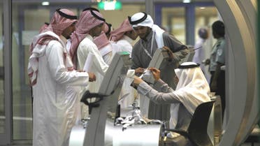 Jobseekers stand in line to talk with a recruiter at a booth at a job fair in Riyadh, January 29, 2012. (Reuters)
