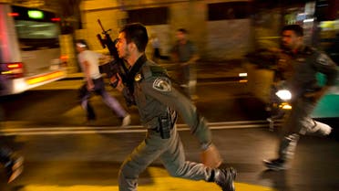 Israeli policemen run looking for a possible stabbing suspect in Jerusalem. (AP)