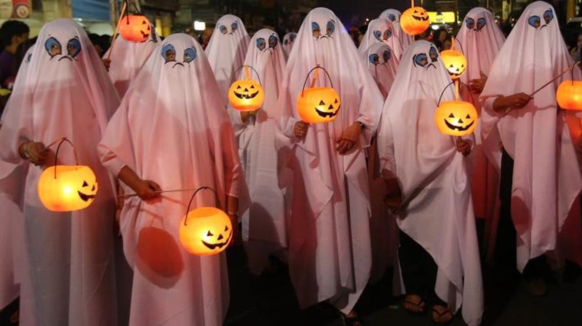 Filipinos wear ghost costumes as they join a Halloween Parade in Marikina city, east of Manila, Philippines on Wednesday, Oct. 30, 2013. Hundreds of residents and government employees joined the parade as the country prepares to observe All Saints Day on Nov. 1. (AP Photo/Aaron Favila)