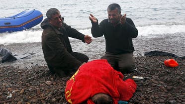 ATTENTION EDITORS - VISUAL COVERAGE OF SCENES OF INJURY OR DEATH The body of a 65-year old Iraqi refugee woman is covered with a towel as her husband (R) and a relative mourn, following their arrival on the Greek island of Lesbos in a dinghy, after crossing a part of the Aegean Sea from the Turkish coast, October 16, 2015. According to the relatives, the woman drowned while the members of the family were forced violently by smugglers to leave the Turkish coasts in a dinghy that filled immediately with sea water. REUTERS/Giorgos Moutafis