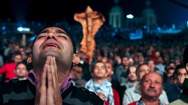 In this Thursday, Dec. 13, 2012 photo, Egyptian Christians gather for a prayer rally ahead of the constitutional referendum at Samaan el-Kharaz church in Cairo, Egypt.