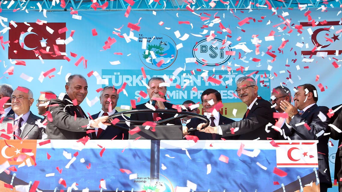Turkish President Recep Tayyip Erdogan, center left, Turkish Cypriot leader Mustafa Akinci, third left, Turkish Prime Minister Ahmet Davutoglu, fourth right, Turkish Deputy Prime Minister Tugrul Turkes, second left, inaugurate an undersea pipeline to carry fresh water from Turkey to the breakaway Turkish Cypriot north of Cyprus _ a project which Greek Cypriot officials have decried as a Turkish ploy to cement its grip on the island, during a ceremony in Anamur, Turkey, Saturday, Oct. 17, 2015.(AP Photo/Presidential Press Service, Pool)