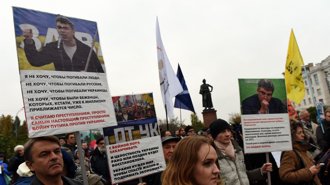 MAX1626 - Moscow, -, RUSSIAN FEDERATION : Demonstrators hold cardboard bearing portraits of assassinated Russian opposition leader Boris Nemtsov, during an antiwar rally in central Moscow on October 17, 2015. Russian Prime Minister Dmitry Medvedev said on October 17 that Russia is fighting for its national interests in Syria, not for President Bashar al-Assad. AFP PHOTO / VASILY MAXIMOV