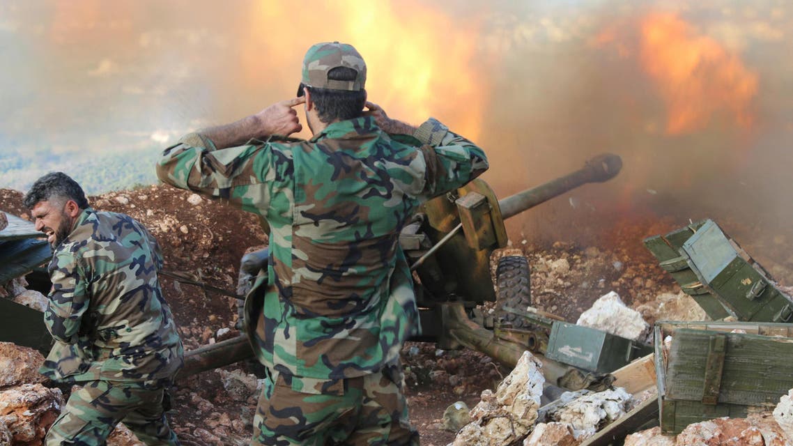  In this photo taken on Saturday, Oct. 10, 2015, Syrian army personnel fire a cannon in Latakia province, about 12 from the border with Turkey in Syria. Backed by Russian airstrikes, the Syrian army has launched an offensive in central and northwestern regions. (Alexander Kots/Komsomolskaya Pravda via AP)