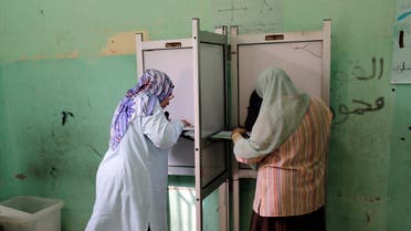  Egyptian voters cast their ballots at a polling station during the first round of parliamentary elections, in Giza, Cairo, Egypt, Sunday, Oct. 18, 2015. (AP Photo/Amr Nabil)