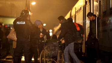 Migrants exit a train at a train station in Sredisce ob Dravi, Slovenia October 17, 2015. Migrants streaming across the Balkans reached Slovenia on Saturday, diverted overnight by the closure of Hungary's border with Croatia in the latest demonstration of Europe's disjointed response to the flow of people reaching its borders. Croatia began directing migrants west to Slovenia, which said they would be registered before continuing their journey to Austria and Germany, the preferred destination of the vast majority, many of them Syrians fleeing war. REUTERS/Srdjan Zivulovic TPX IMAGES OF THE DAY
