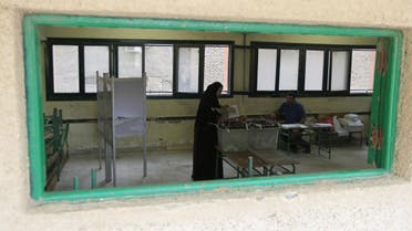A woman casts her vote during parliamentary elections at a voting centre in Giza governorate, Egypt. (Reuters)