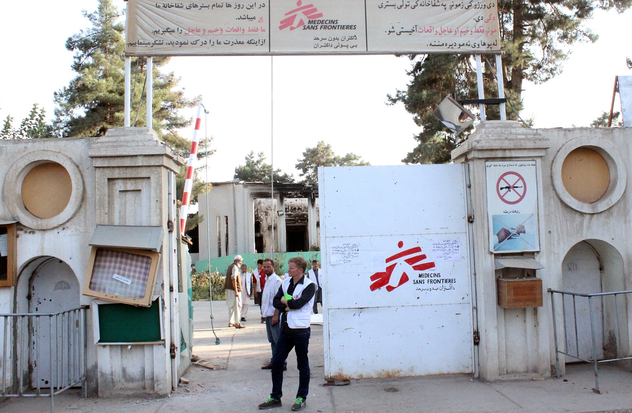In this Thursday, Oct. 15, 2015 photo, Christopher Stokes, the general director of medical charity Doctors Without Borders, which is also known by its French abbreviation MSF, stands at the gate of the organization's hospital, after it was hit by a U.S. airstrike, in Kunduz, Afghanistan.