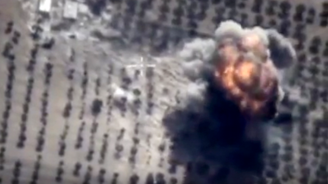 In this photo made from the footage taken from Russian Defense Ministry official web site on Friday, Oct. 16, 2015 showing a target hit during s Russian air raid in Syria. Russian Defense Ministry said the strike was performed by an Su-24M bomber in Idlib province. (AP Photo/ Russian Defense Ministry Press Service)