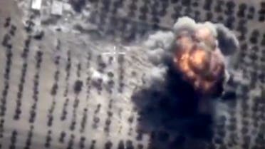In this photo made from the footage taken from Russian Defense Ministry official web site on Friday, Oct. 16, 2015 showing a target hit during s Russian air raid in Syria. Russian Defense Ministry said the strike was performed by an Su-24M bomber in Idlib province. (AP Photo/ Russian Defense Ministry Press Service)