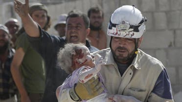 ATTENTION EDITORS - VISUAL COVERAGE OF SCENES OF INJURY OR DEATHA civil defence member carries an injured baby that survived from under debris at a site hit by what activists said was an airstrike by forces loyal to Syria's President Bashar al-Assad, in the town of Marshamsha, in the southern countryside of Idlib, Syria October 20, 2015. REUTERS/Khalil AshawiFOR EDITORIAL USE ONLY. NO RESALES. NO ARCHIVE.
