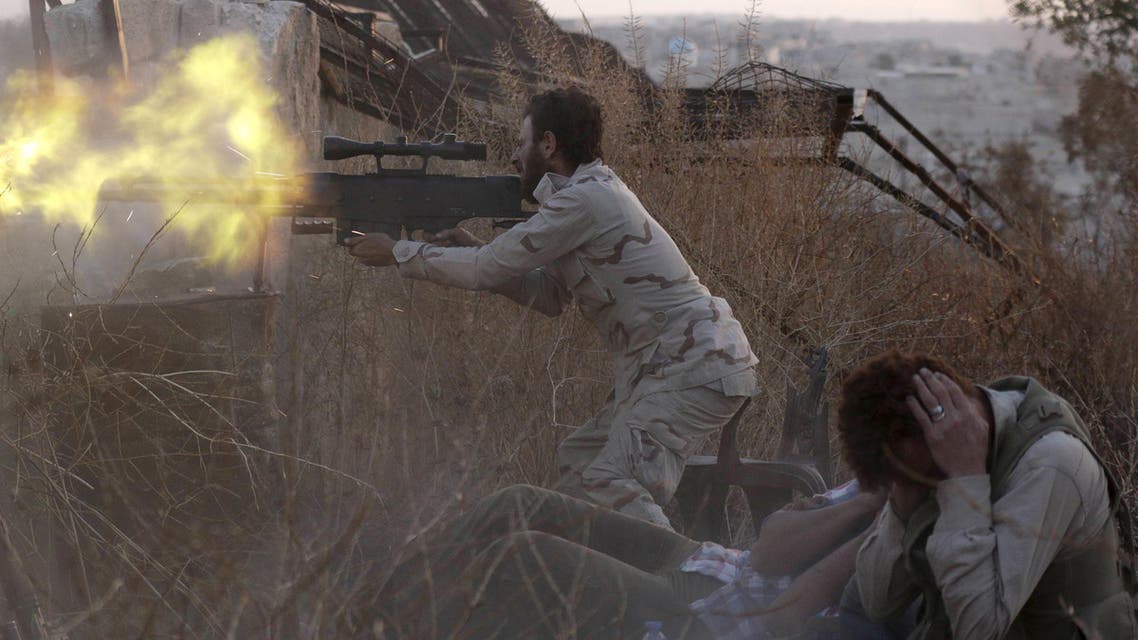 A rebel fighter fires a weapon as a fellow fighter covers his ears during clashes with forces loyal to Syria's President Bashar al-Assad on the frontline of Aleppo's Sheikh Saeed neighbourhood May 23, 2015. (Reuters)