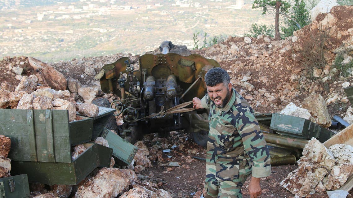 In this photo taken on Saturday, Oct. 10, 2015, a Syrian army soldier fires a cannon in Latakia province, about 12 from the border with Turkey in Syria. Backed by Russian airstrikes, the Syrian army has launched an offensive in central and northwestern regions. (Alexander Kots/Komsomolskaya Pravda via AP)