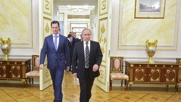 Russian President Putin and Syrian President Assad enter a hall during a meeting at the Kremlin in Moscow
