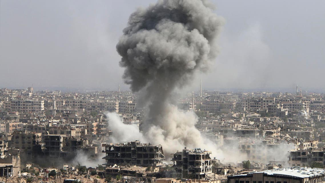 In this photo taken on Wednesday, Oct. 14, 2015, smoke rises after shelling by the Syrian army in Jobar, Damascus, Syria. Backed by Russian airstrikes, the Syrian army has launched an offensive in central and northwestern regions. (Alexander Kots/Komsomolskaya Pravda via AP) RUSSIA OUT