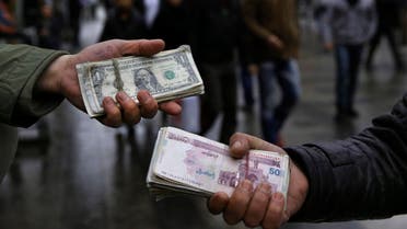 Iranian street money exchangers show currencies at Tehran's old main bazaar (AP)