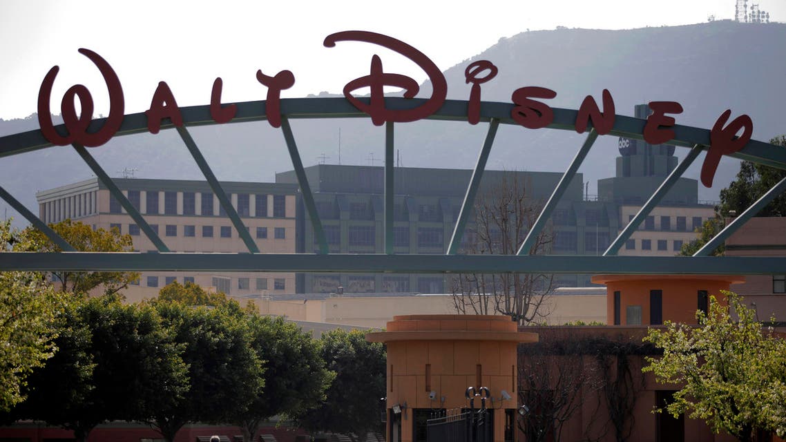 People stand near the entrance to the Walt Disney Studios is seen in Burbank , Calif., Tuesday, Feb. 8, 2011. Walt Disney Co. releases quarterly financial earnings Tuesday, after the market close.(AP