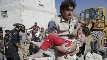 Civil defense member carries an injured girl that survived from under debris at a site hit by what activists said was an airstrike by forces loyal to Syria's President Bashar al-Assad in the southern countryside of Idlib. (File: Reuters)