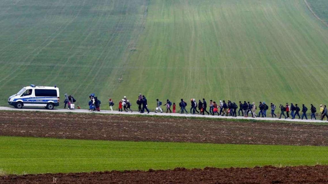 Migrants are escorted by German police to a registration centre, after crossing the Austrian-German border in Wegscheid near Passau, Germany. (Reuters)