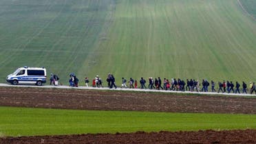 Migrants are escorted by German police to a registration centre, after crossing the Austrian-German border in Wegscheid near Passau, Germany. (Reuters)