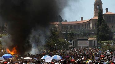 Students burn portable toilets during their protest against university tuition hikes outside the union building in Pretoria, South Africa, Friday, Oct. 23, 2015. AP