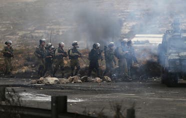 Israeli soldiers and policemen take position during clashes with Palestinians near the Jewish settlement of Bet El, near the West Bank city of Ramallah. (Reuters)