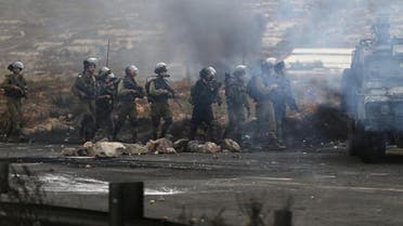 Israeli soldiers and policemen take position during clashes with Palestinians near the Jewish settlement of Bet El, near the West Bank city of Ramallah. (Reuters)