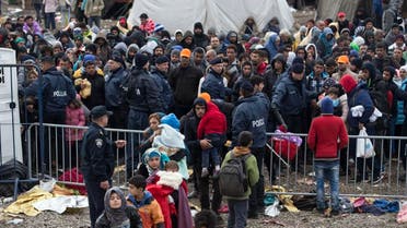 People wait to clear a police line at a registration center for migrants and refugees in Opatovac, Croatia, Wednesday, Oct. 21, 2015. Croatia, Serbia and Slovenia have struggled to cope with the relentless flow of migrants traveling through the Balkans, their journey made more difficult since Hungary erected fences protected by razor wire, police and soldiers on its southern borders, forcing migrants to find new routes west. (AP Photo/Marko Drobnjakovic)