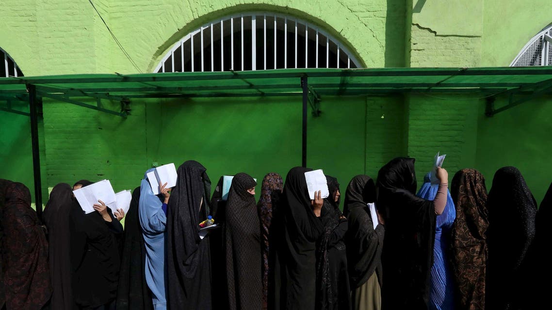 Afghan women queue at the passport department in Herat. (Reuters)