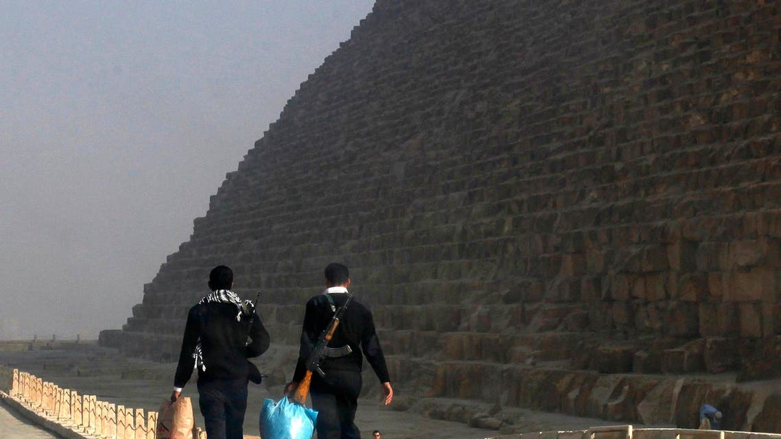 Police officers leave the Giza pyramids area, south of Cairo, at the end of their shift February 20, 2014. (Reuters)