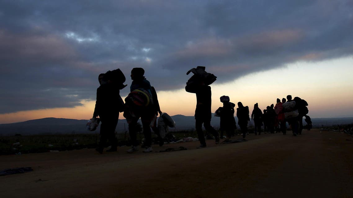 Migrants walk towards a village after entering from Macedonia by foot in Miratovac, Serbia, October 24, 2015. (Reuters)