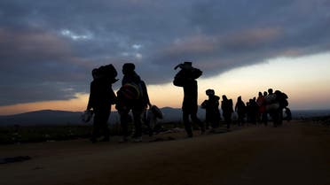 Migrants walk towards a village after entering from Macedonia by foot in Miratovac, Serbia, October 24, 2015. (Reuters)