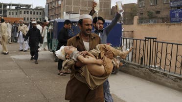 A man carries a boy, who was injured in an earthquake, at the Lady Reading hospital in Peshawar, Pakistan October 26, 2015. (AP)
