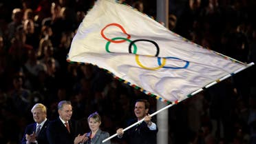 Rio de Janeiro mayor Eduardo Paes waves the olympic flag next to Jacques Rogge and London Mayor Boris Johnson. (File photo: AP)