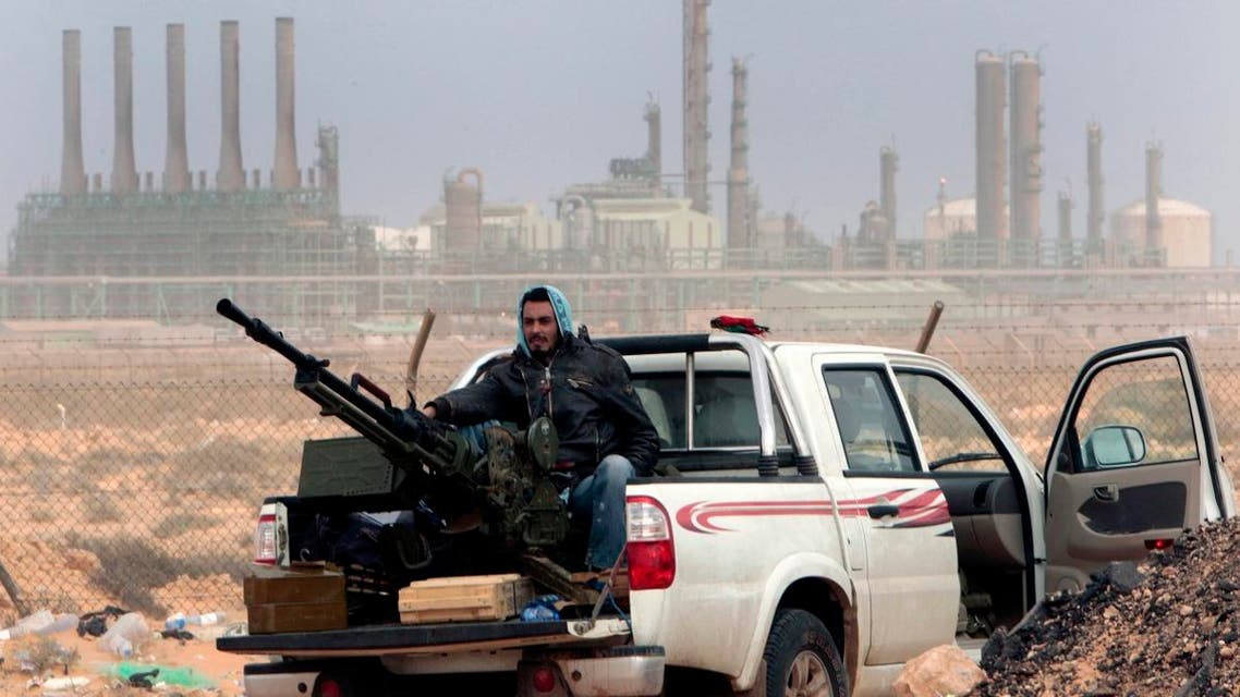 In this March 5, 2011 file photo, an anti-government rebel sits with an anti-aircraft weapon in front an oil refinery, after the capture of the oil town of Ras Lanouf, eastern Libya. (AP)