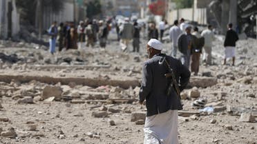 A Houthi militant walks at the site of Saudi-led air strikes in Yemen's capital Sanaa October 28, 2015. reuters 