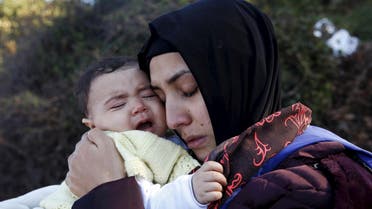 A Syrian refugee hugs her crying baby after arriving on a raft on the Greek island of Lesbos, October 27, 2015. (Reuters)