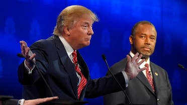 Ben Carson, right, watches as Donald Trump speaks during the CNBC Republican presidential debate at the University of Colorado. (AP)