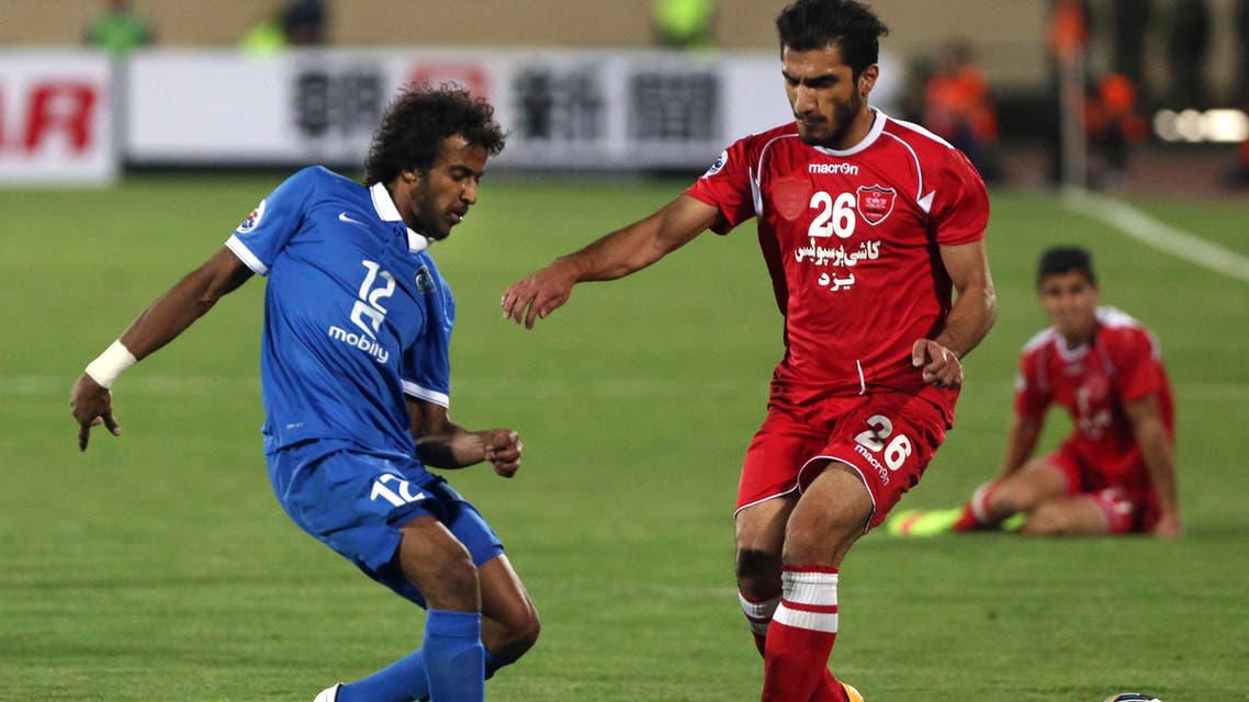  Iran's Persepolis soccer player Hamid Aliasgari, right, and Saudi Arabia's al Hilal player Yasir Alshahrani fight for the ball during their match in AFC Champions League at the Azadi (Freedom) stadium in Tehran, Iran, Tuesday, May 19, 2015. Persepolis won the match 1-0. (AP Photo/Vahid Salemi)