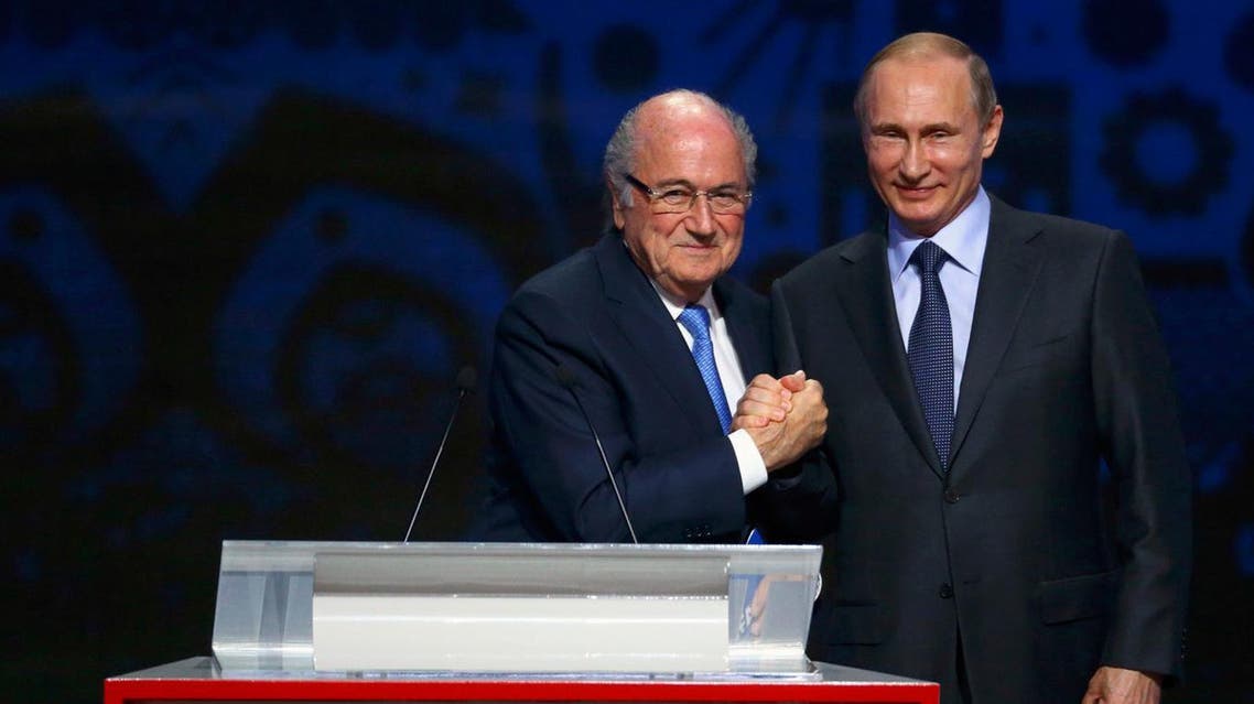 FIFA's President Sepp Blatter shakes hands with Russia's President Vladimir Putin (R) during the preliminary draw for the 2018 FIFA World Cup at Konstantin Palace in St. Petersburg. (Reuters)