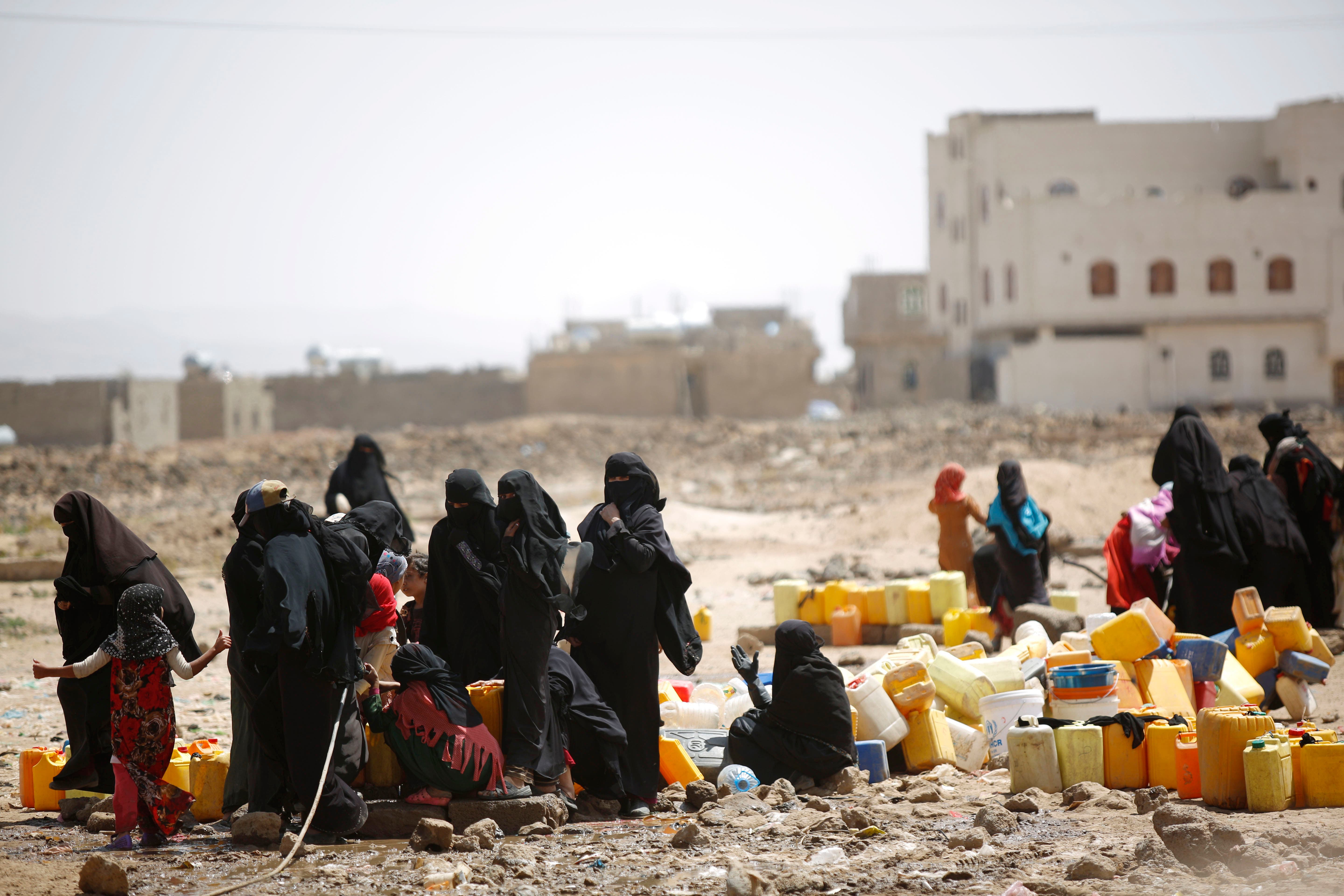 Women and children fill buckets with water from a public tap amid an acute shortage of water, on the outskirts of Sanaa, Yemen, Tuesday, Oct. 13, 2015. (AP)